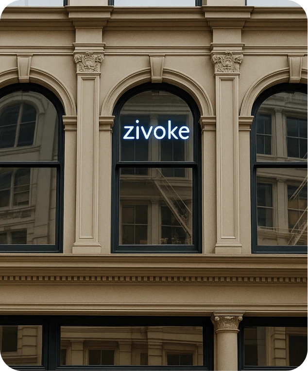 The illuminated Zivoke sign in the window of a historic cast-iron building